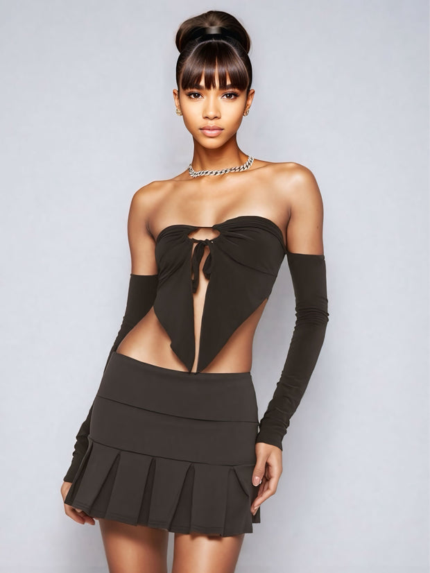 Double Dare pleated mini skirt in black, styled with cut-out top